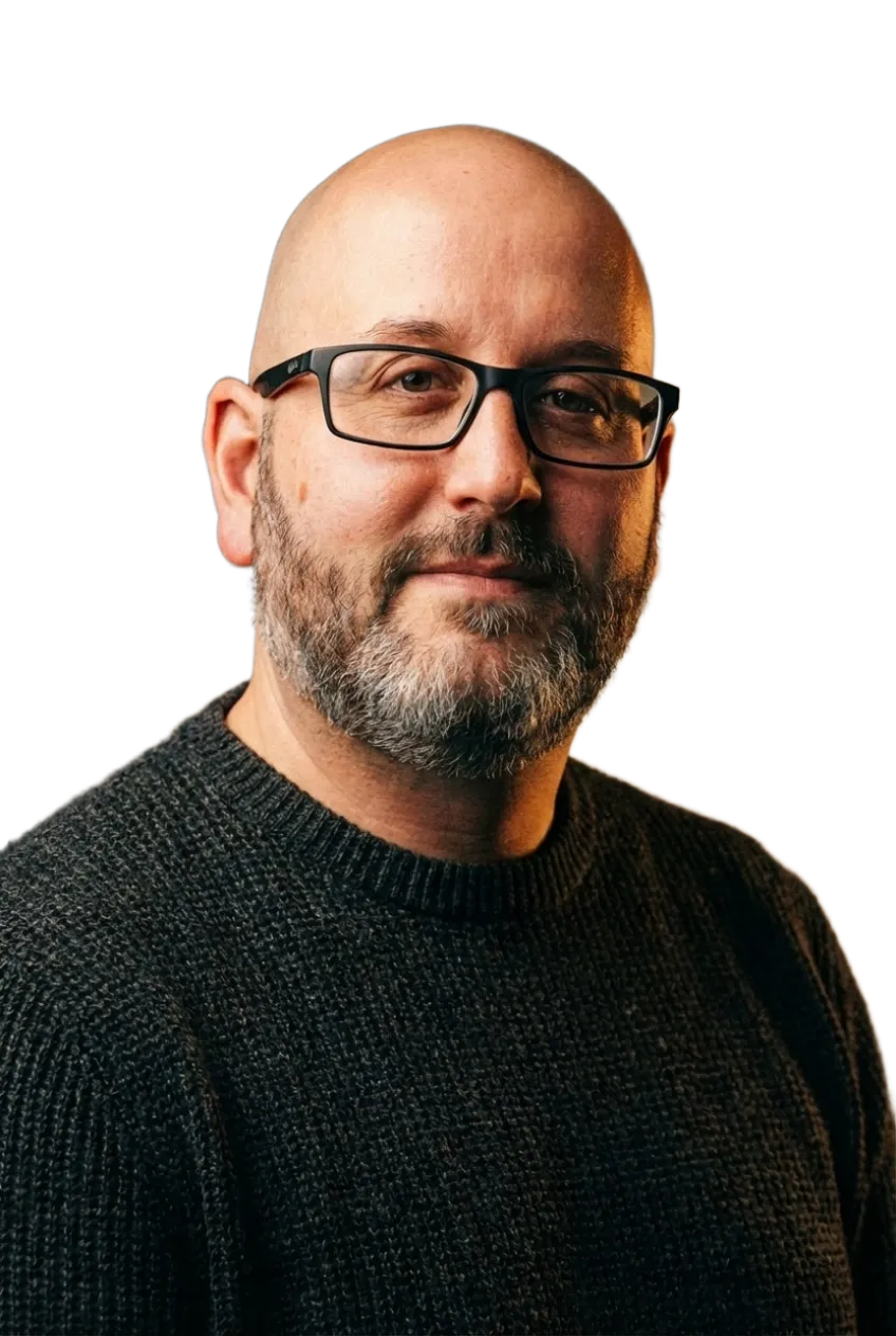 Berry van Es: bald, glasses, dark jumper, slight grin
